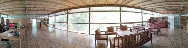 Spacious open-air lodge interior with wooden floors and jungle views, part of 57.5-hectare