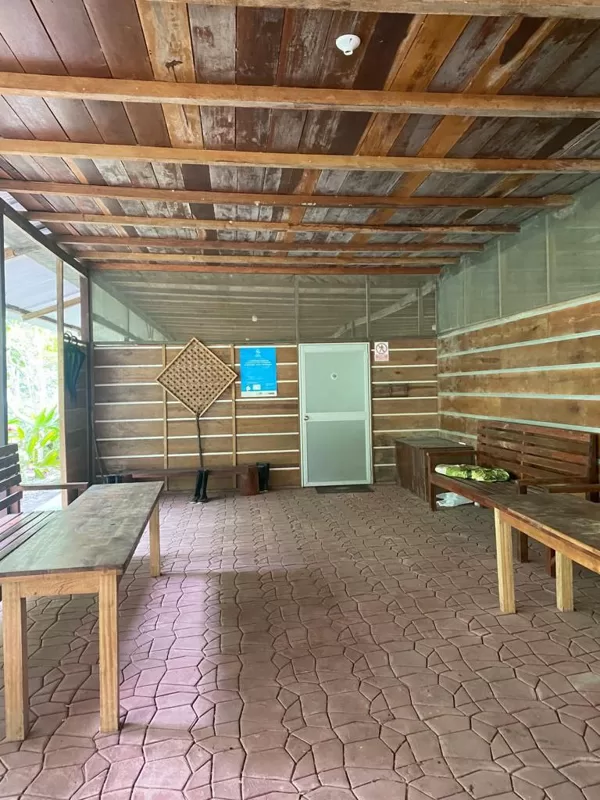 Entrance or utility area in an Amazon retreat lodge with rustic wooden benches, storage ta