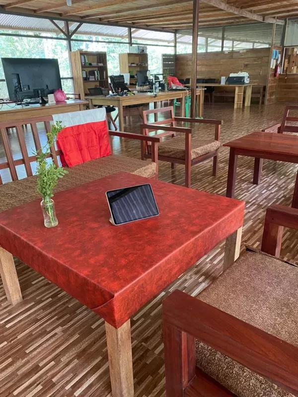 Interior view of a jungle eco-lodge in the Peruvian Amazon, featuring a rustic coworking s